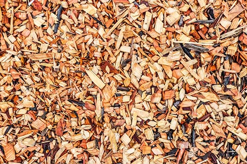 Wood chip mulch displayed in Spoken Garden's "How to Mulch in 6 Basic Steps" post