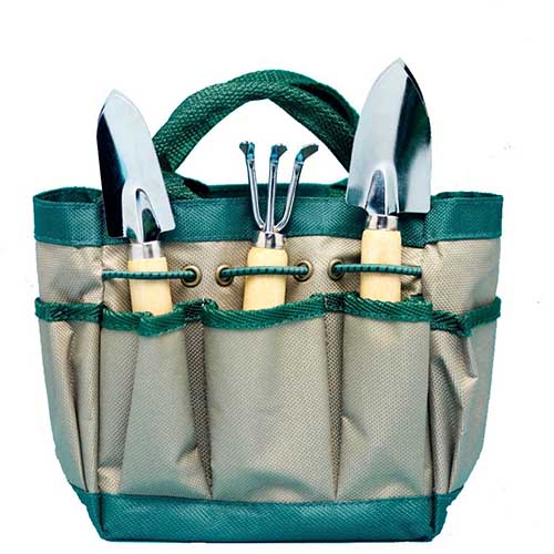 A canvas bag holding 3 different garden hand tools in Spoken Garden's "Best Garden Tool Sets" tool review post. 